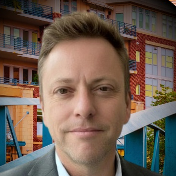 Chris Lockhart, founder of Kit & File, in a gray blazer in downtown Greenville, South Carolina